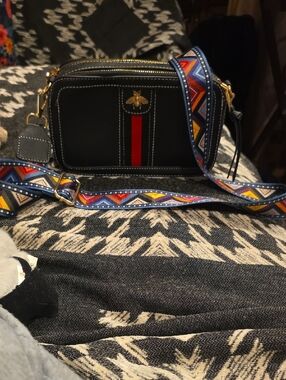 Black Crossbody Camera Bag with Red Stripe and Embossed Bee